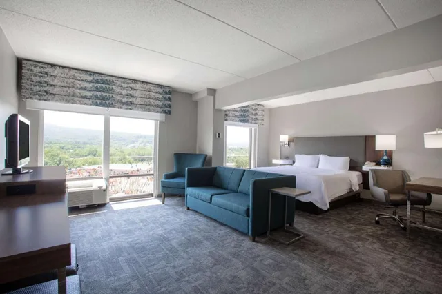 غرفة بسرير كينج مع أريكة بمنطقة جلوس، HAMPTON INN BEDFORD 3/6