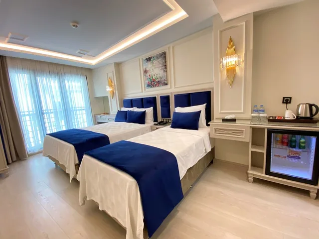 غرفة ديلوكس ثلاثية بسرير مزدوج وسرير فردي، Omma Hotel 1/4