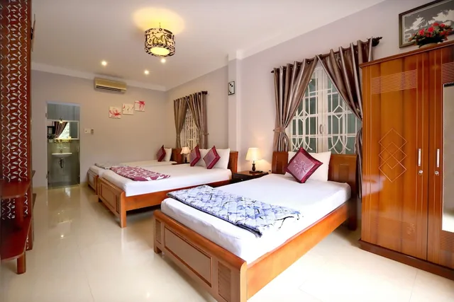 غرفة عائلية بسرير كوين وسرير فردي بإطلالة على الحديقة بشرفة، Green Garden Homestay 2/6