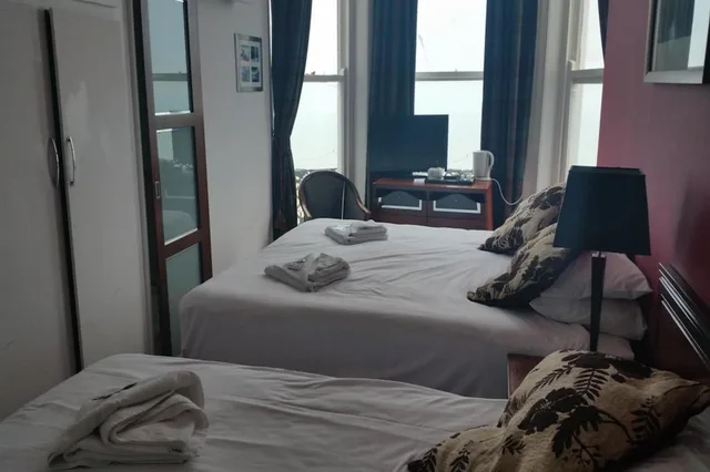 Family, 1 Double and 1 Single Bed, OYO The Strand Hotel 2/6