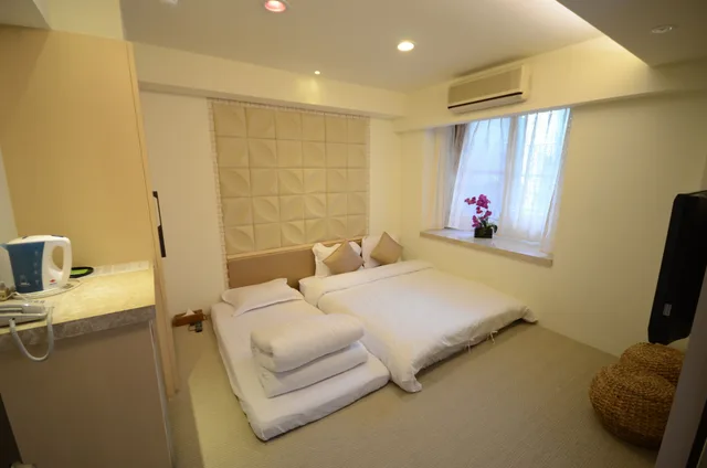 غرفة ديلوكس ثلاثية بسرير مزدوج وسرير فردي، Mingao Spring Hotel 1/1