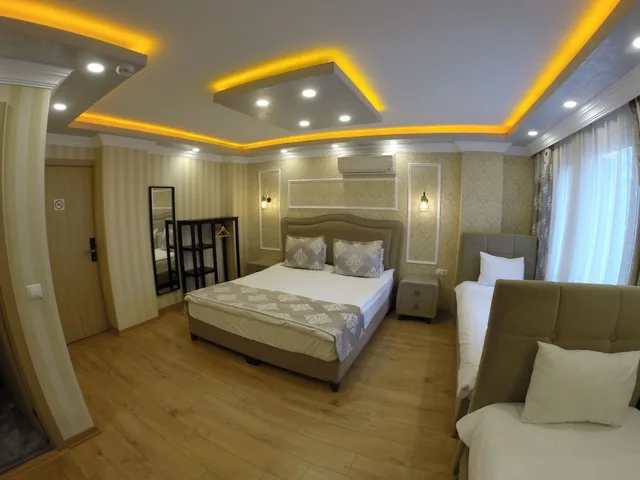 غرفة ديلوكس رباعية بسرير كوين وسرير فردي مع أريكة، Meydan Suites 2/3