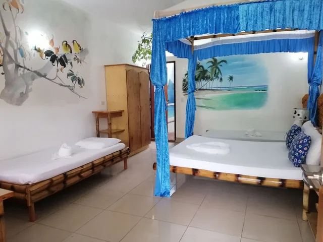 غرفة اقتصادية رباعية بسرير كوين وسريرين منفصلين، Kokosnuss Garden Resort 4/4
