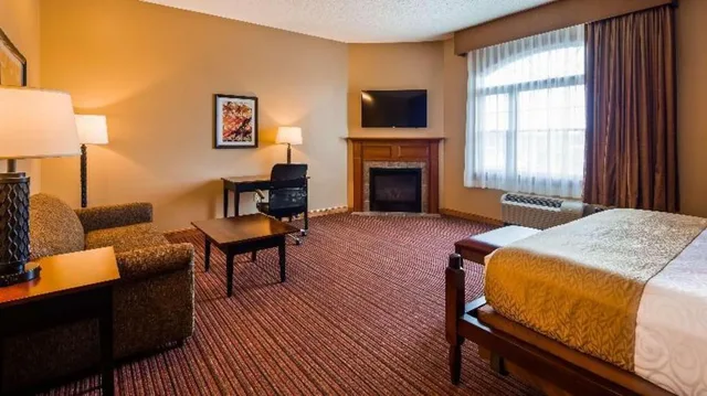 غرفة بسرير كينج مع أريكة بحوض جاكوزي بمطبخ صغير، Best Western Plus Dutch Haus Inn And Suites 2/4