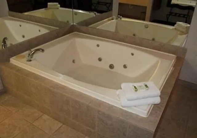 جناح ديلوكس بسرير كينج وسريرين كوين بغرفتي نوم بحوض جاكوزي، Crown Choice Inn Suites Lakeview Waterpark 1/1