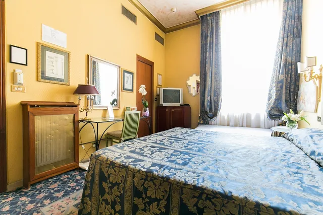 غرفة رباعية بسرير كينج وسريرين منفصلين، Hotel Celio 1/3