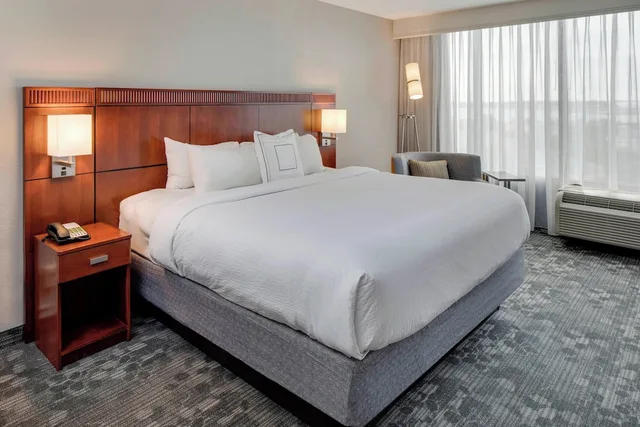 غرفة بسرير كينج مع أريكة، COURTYARD BY MARRIOTT LOGAN AIRPORT 5/10