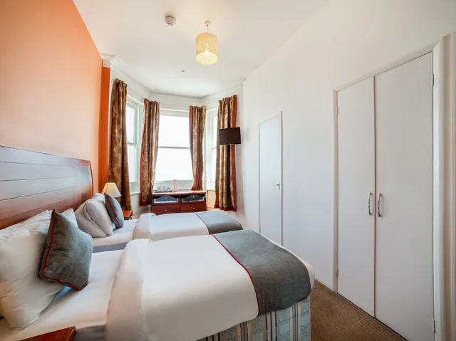 Family, 1 Double and 1 Single Bed, OYO The Strand Hotel 1/6